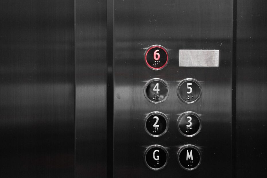 a close up of a metal elevator with buttons