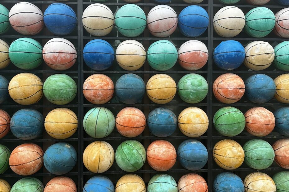 a rack of basketballs with different colors on them