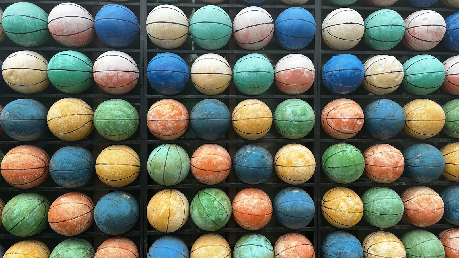 a rack of basketballs with different colors on them