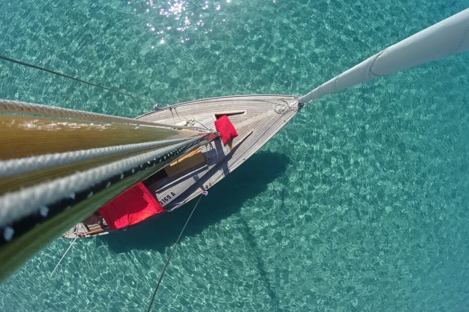 white and pink sailboat at sea during daytiem