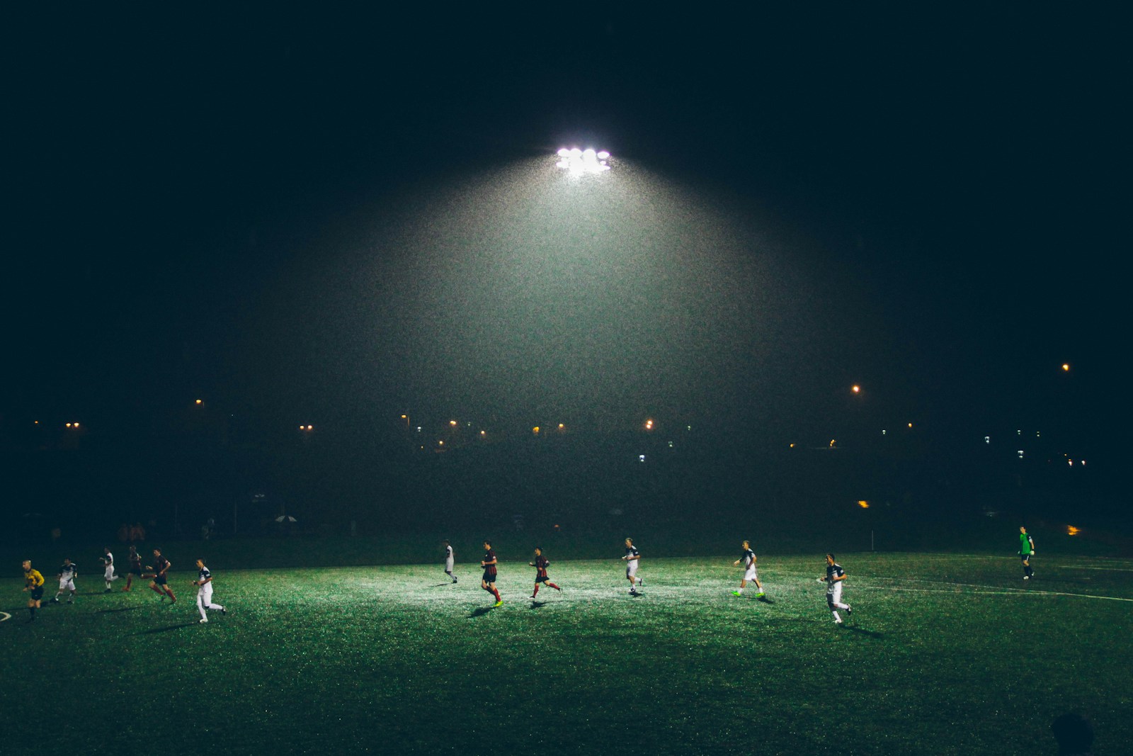 group of people playing soccer on soccer field