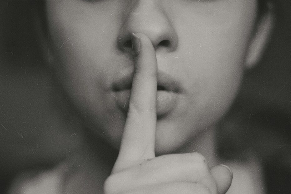 grayscale photo of woman doing silent hand sign