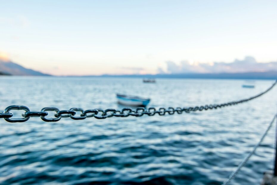 boat on sea water under sunny sky