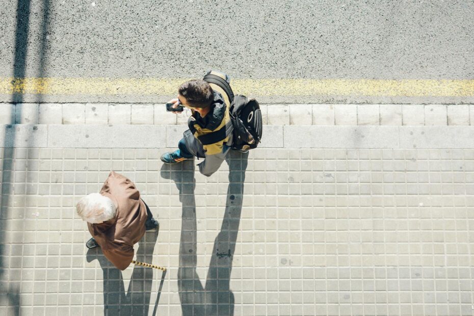 Top view of people walking on a sunny street in Barcelona, Spain.