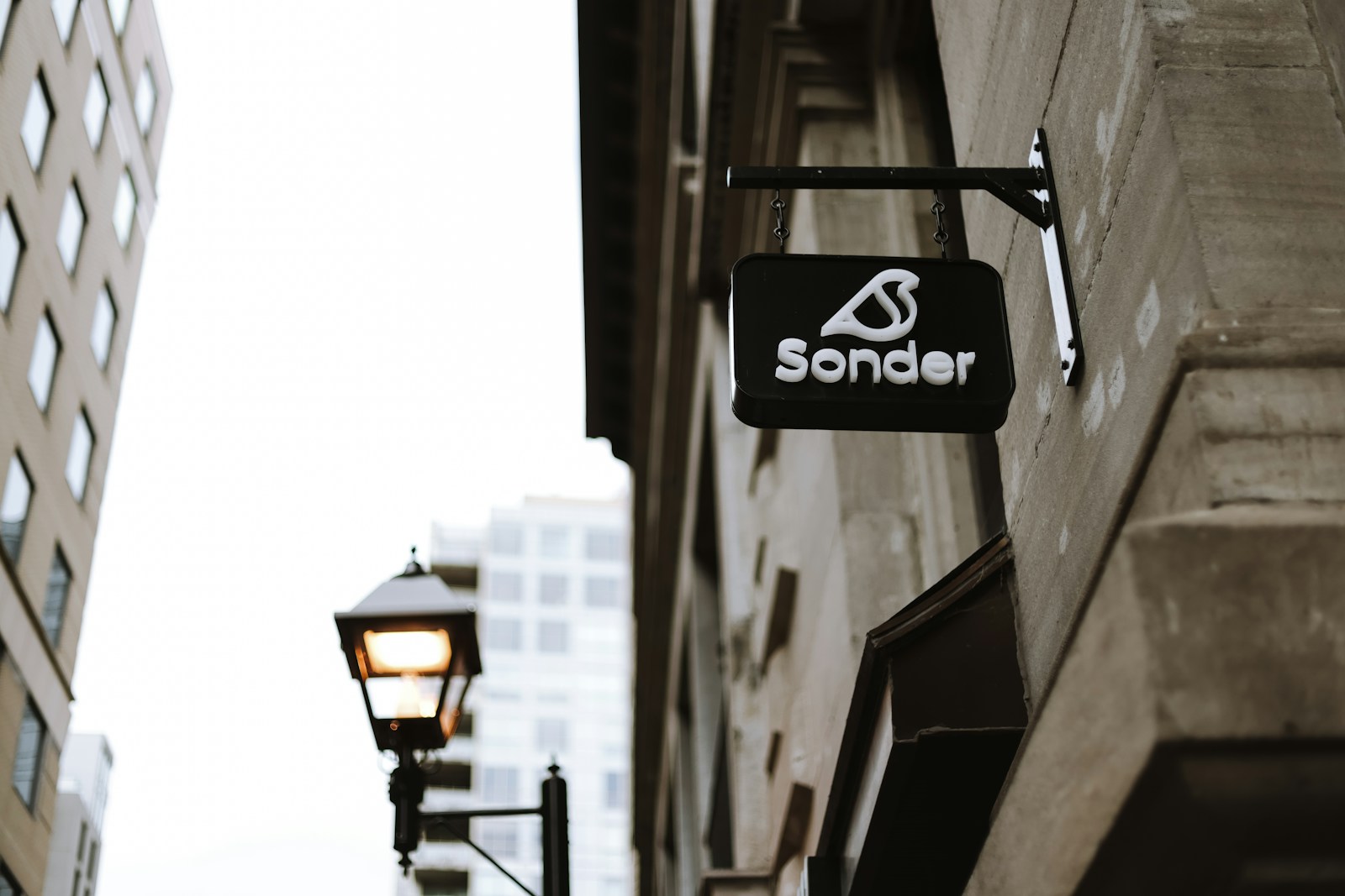 A street sign hanging off the side of a building